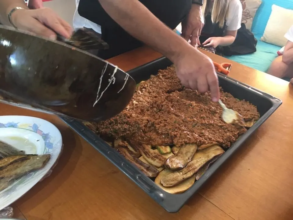 Making moussakas at a cooking class image.