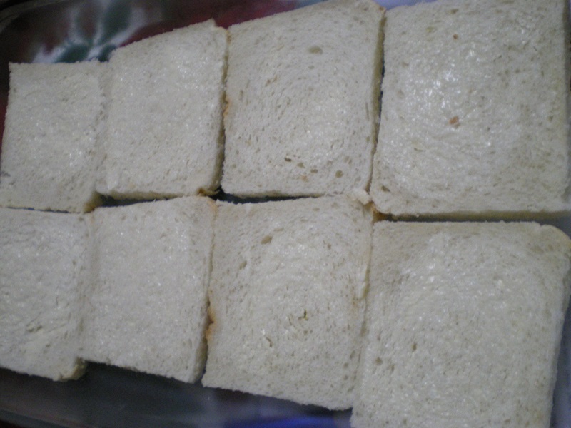 Slices of bread lightly buttered image
