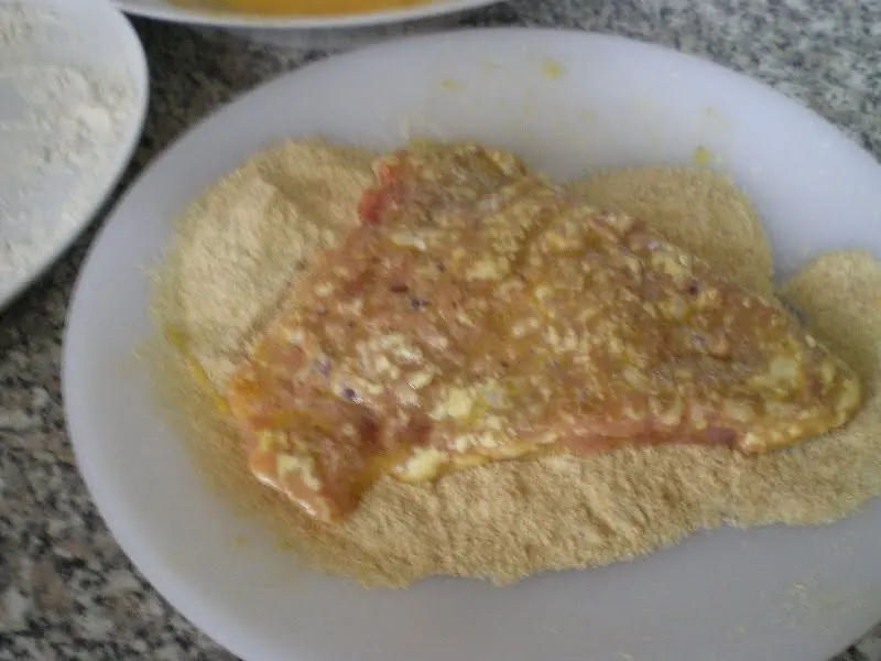 Dipping them in breadcrumbs image