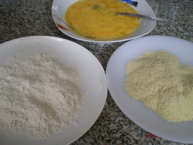three plates eggs flour breadcrumbs