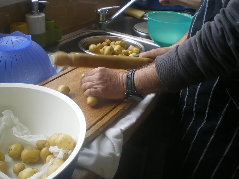 cleaning-potatoes Smashing the potatoes with a dowel image