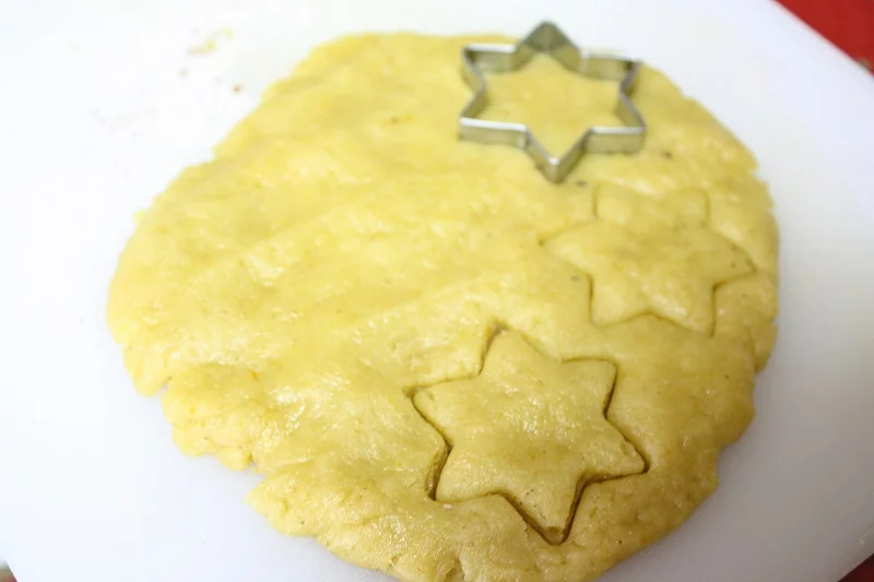 Cutting melomakarona with a cookie cutter image