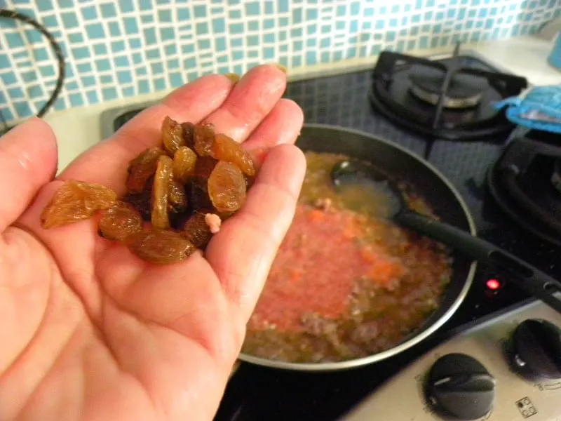 Adding raisins to the rice image