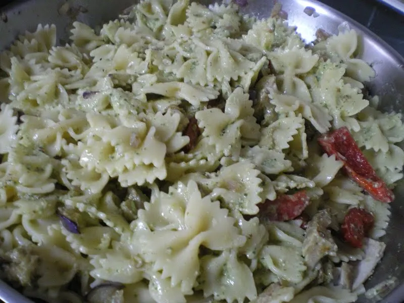 Adding pasta and pesto image