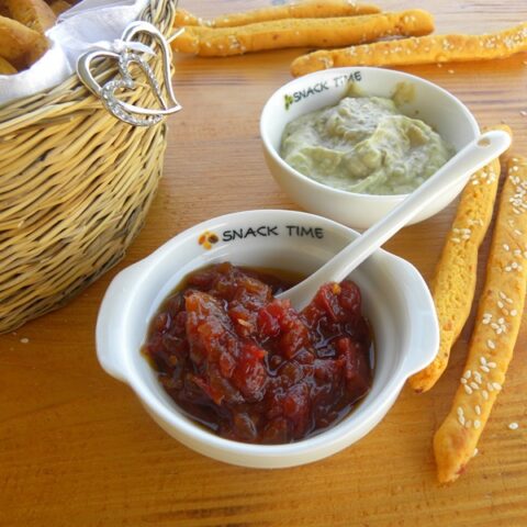 Chutney in a bowl with bread sticks image