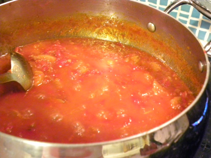 Tomato chutney simmering in a pot image