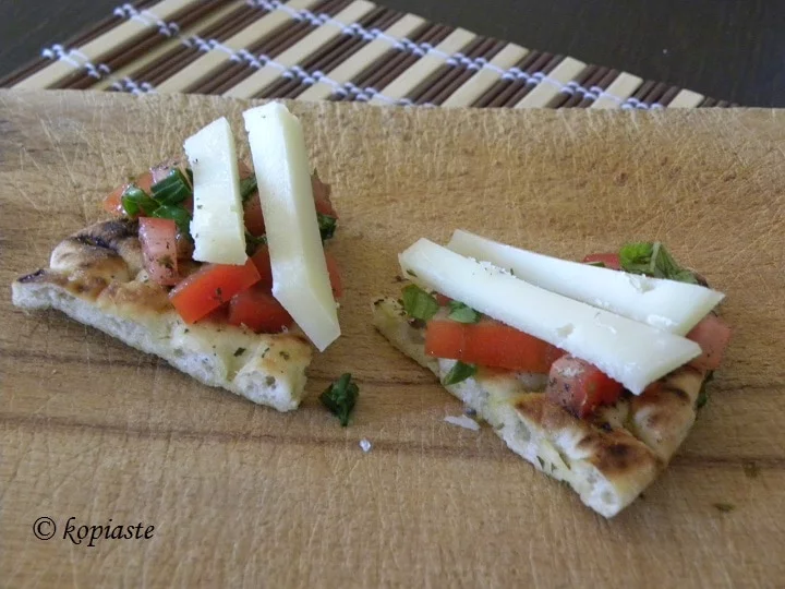 Pita chips with tomato, basil and graviera