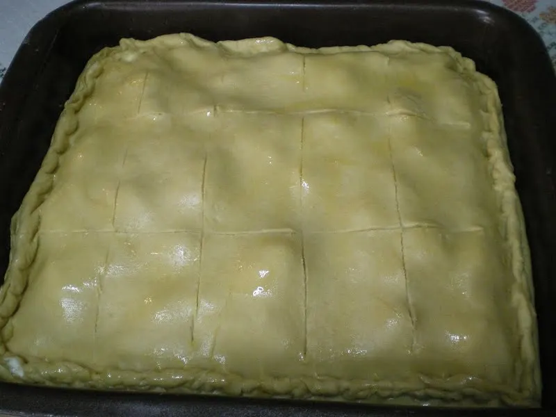 Tyropita kourou scored before baking image