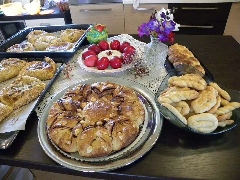 Table filled with Easter tsourekia, flaounes, koulourakia image
