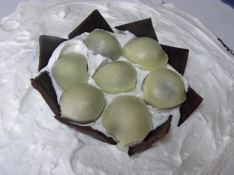 Adding dark chocolate to form the nest image