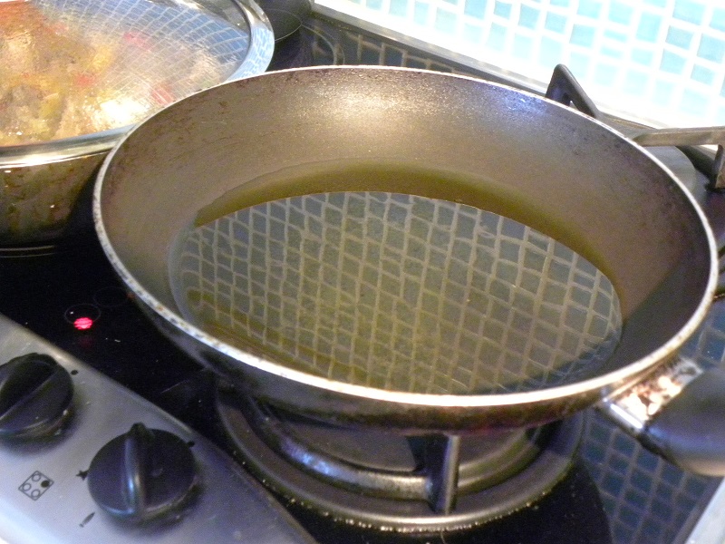 Heating the olive oil in a frying pan image