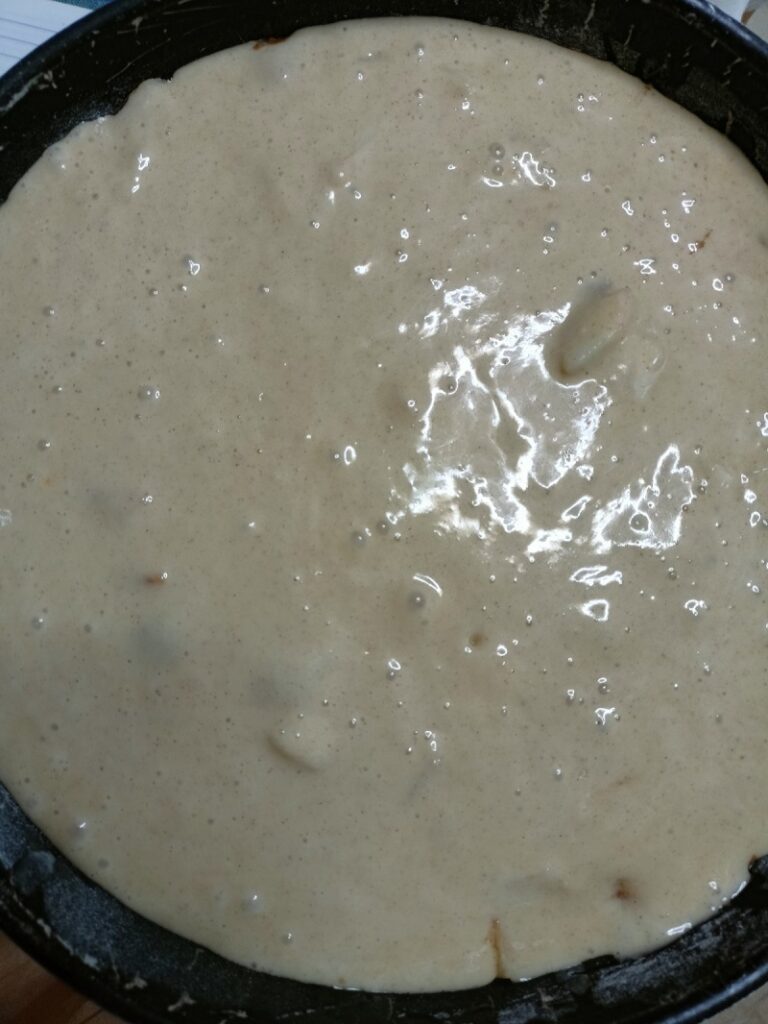 Pouring batter over apples image