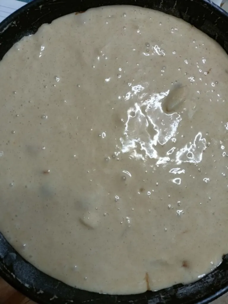 Pouring batter over apples image