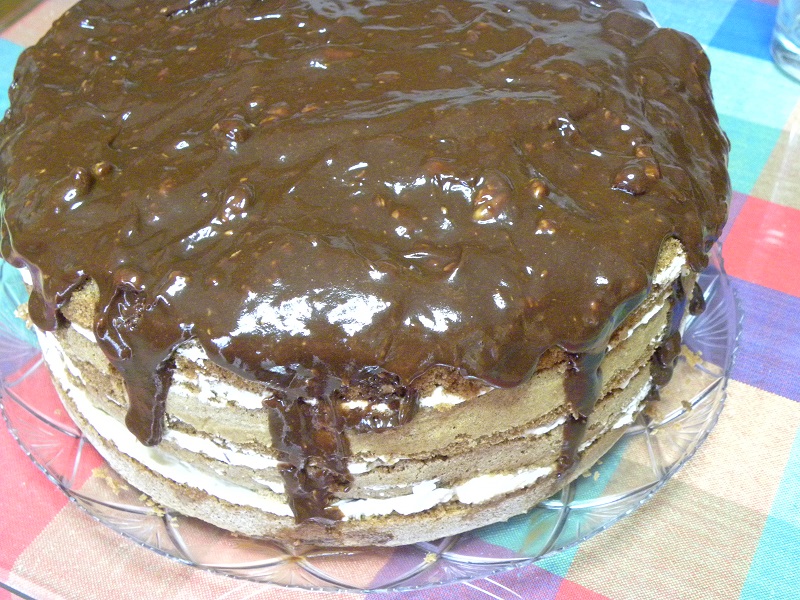 Pouring the mars ganache on top of the cake image