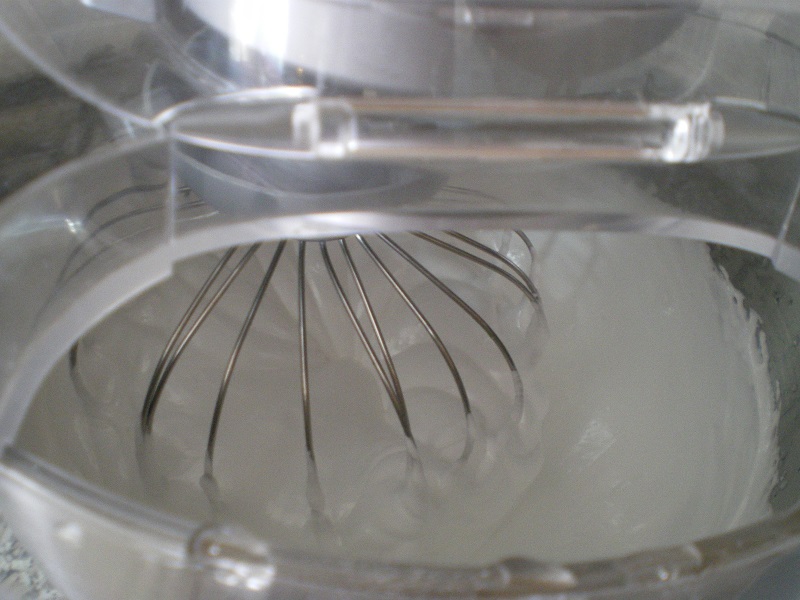 Whisking the gelatin with the hot syrup image