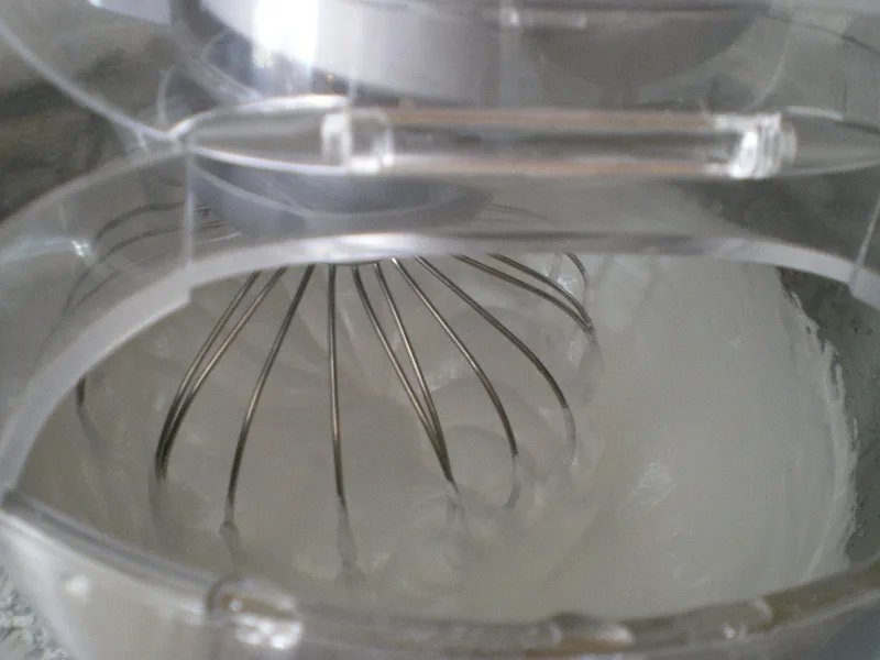 Whisking the gelatin with the hot syrup image