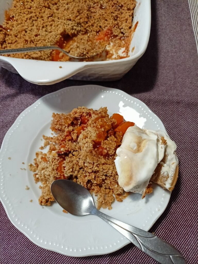 Apricot crumble served with ice cream image